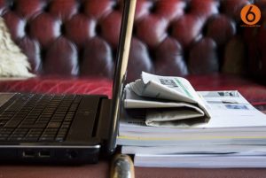 Laptop against newspaper
